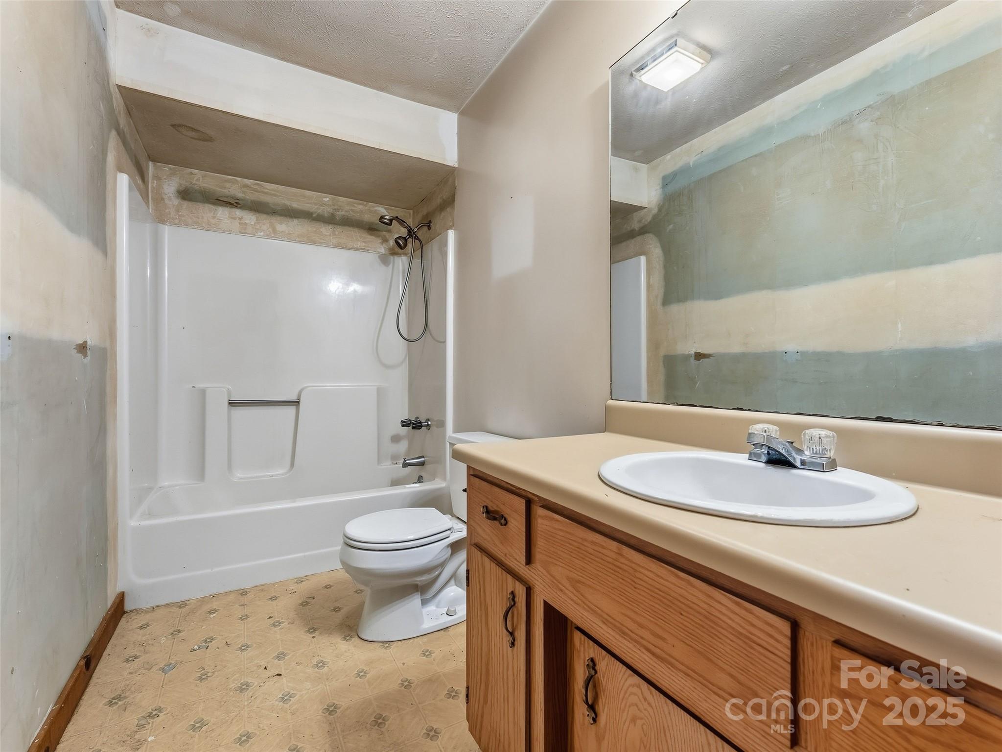 6130 Howard Gap Road Saluda, NC 28773 - Photo 17 of 27 a bathroom with a sink a toilet and shower