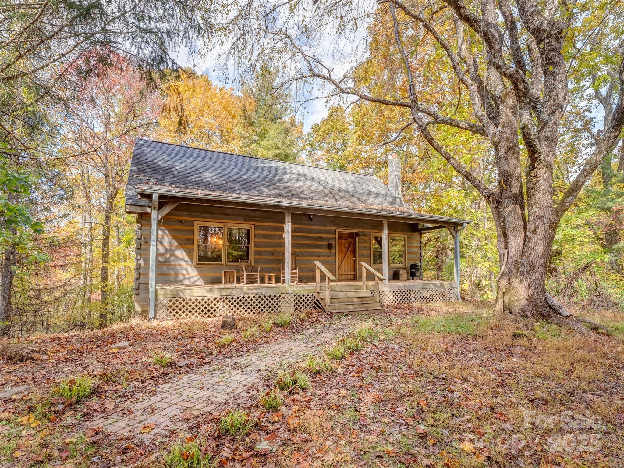 6130 Howard Gap Road Saluda, NC 28773 - Photo 2 of 27 a front view of a house with garden