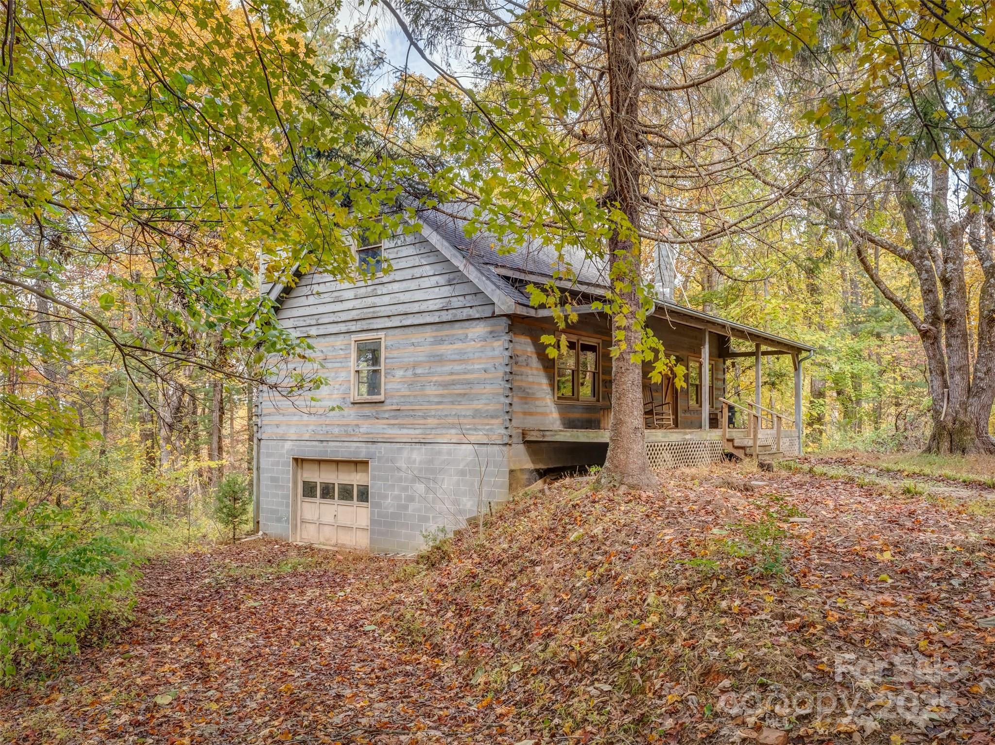 6130 Howard Gap Road Saluda, NC 28773 - Photo 21 of 27 front view of a house with a trees
