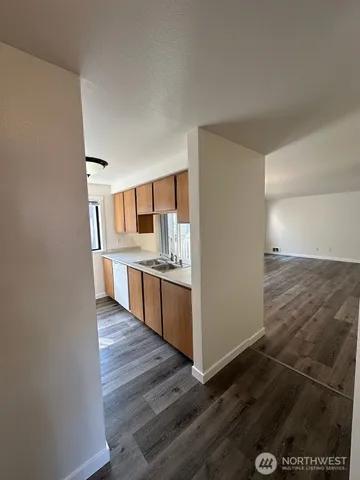 a large kitchen with granite countertop a large counter top space and stainless steel appliances