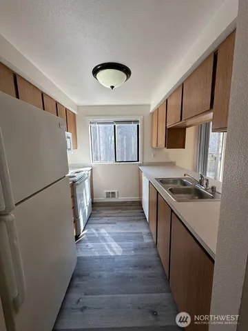 a kitchen with a refrigerator a stove top oven and a refrigerator