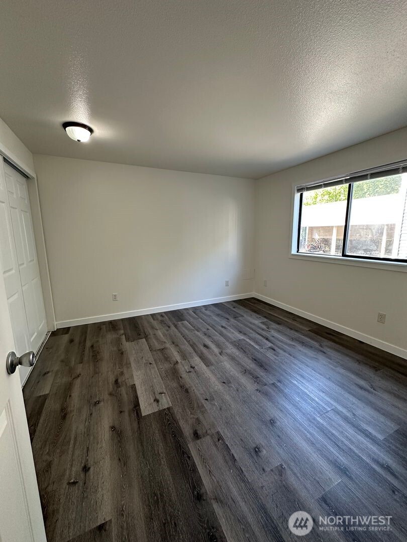 2515 Melvin Avenue, Unit C Everett, WA 98203 - Photo 10 of 13 an empty room with wooden floor and windows