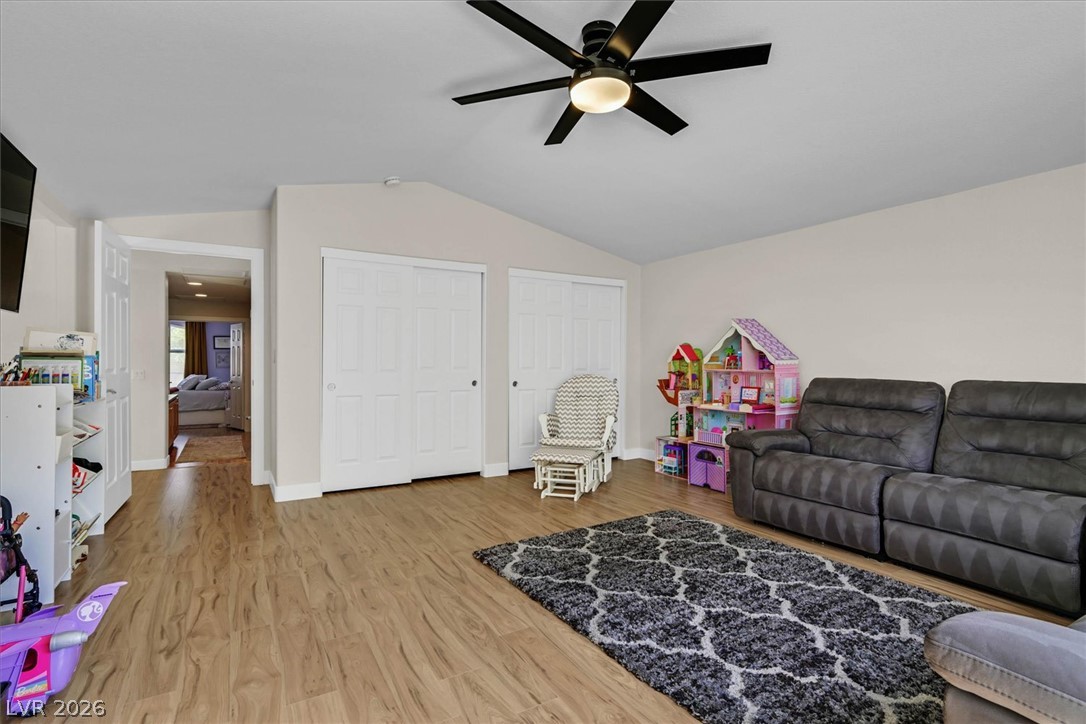 1259 Moon Vision Street Henderson, NV 89052 - Photo 26 of 53 A well-lit play area features durable wood flooring and a refreshing ceiling fan.