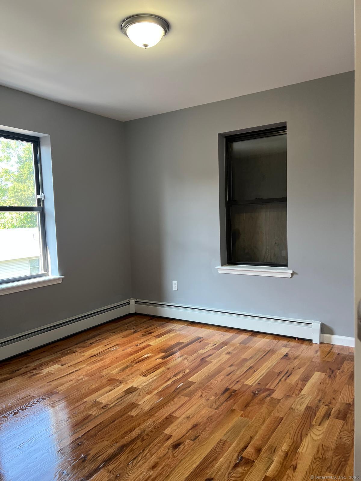 79 Barbour Street, Unit N2 Hartford, CT 06120 - Photo 7 of 7 a view of an empty room with wooden floor and a window