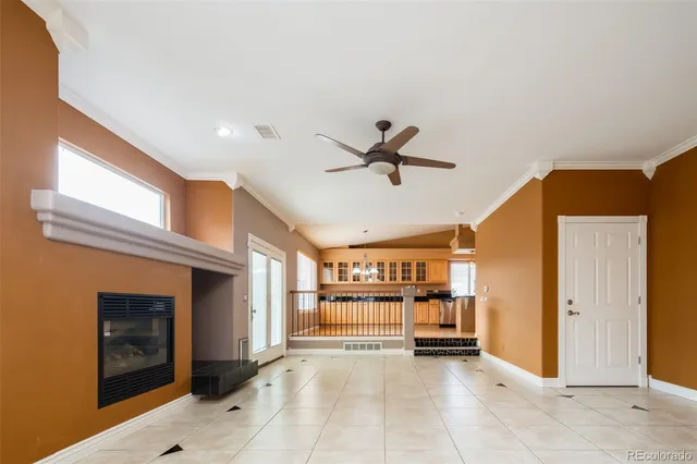 a view of a livingroom with a ceiling fan and window