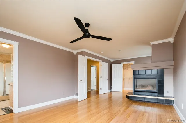 a view of empty room with wooden floor and fireplace