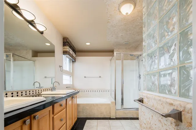 a spacious bathroom with a granite countertop sink and a mirror