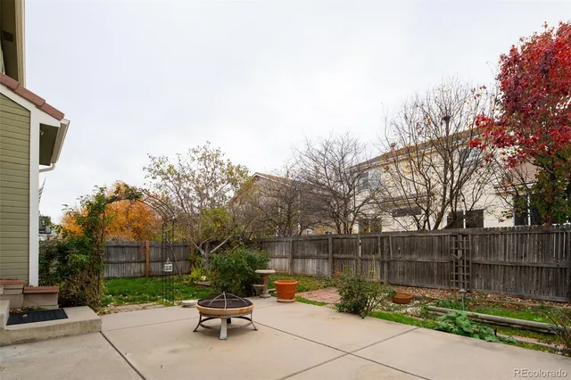 a swimming pool with outdoor seating and garden