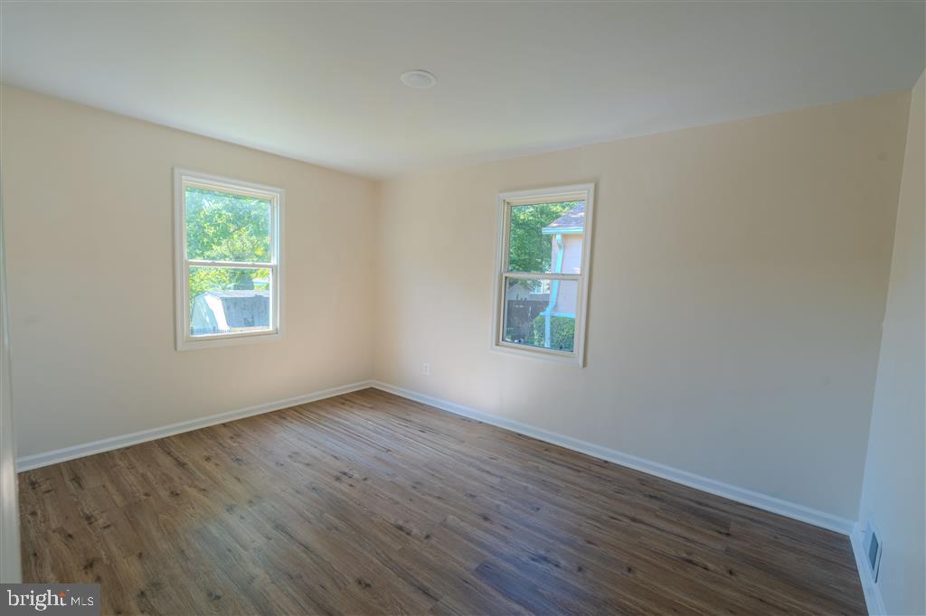 12324 Centerhill Street Silver Spring, MD 20902 - Photo 10 of 24 an empty room with wooden floor and windows