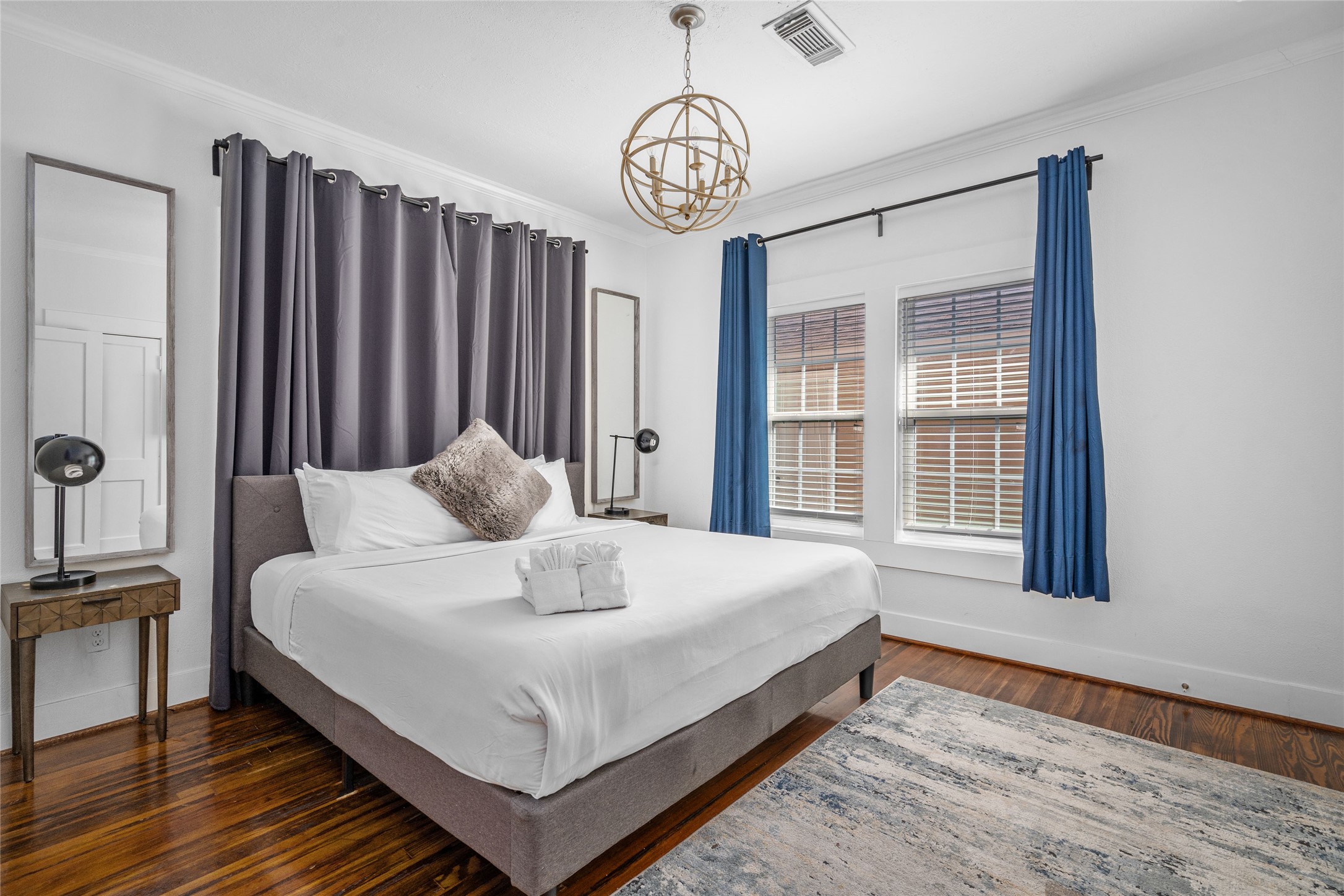 5302 Lindsay Street Houston, TX 77023 - Photo 15 of 37 a large bed sitting in a bedroom next to a window and a chandelier