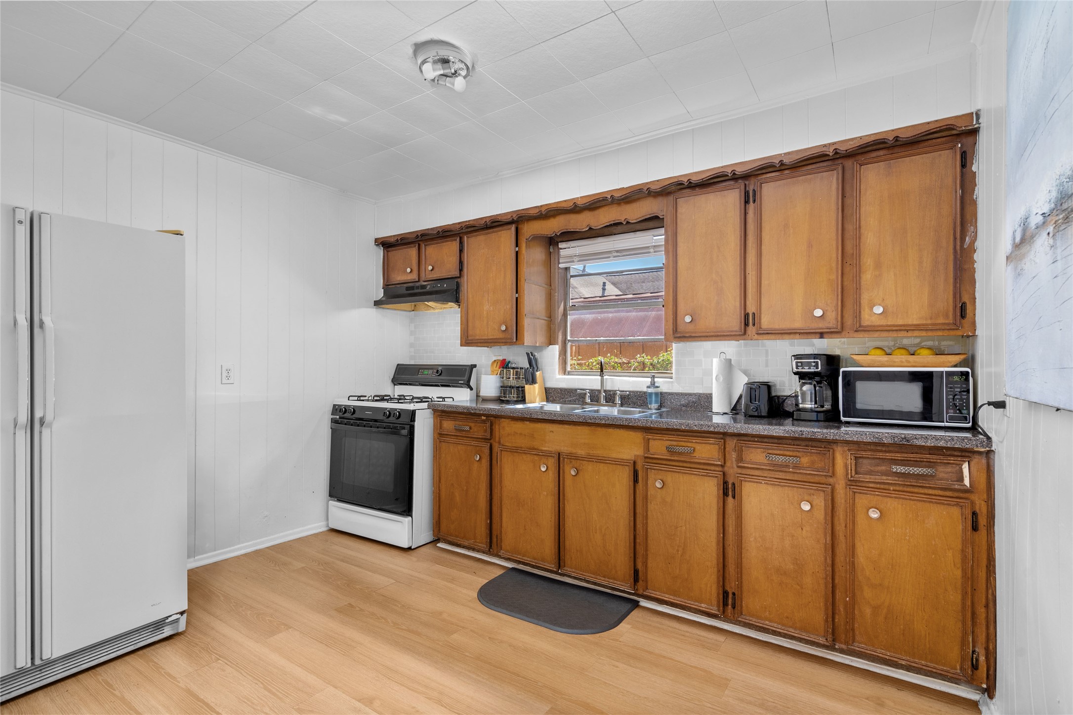 5302 Lindsay Street Houston, TX 77023 - Photo 24 of 37 a kitchen with stainless steel appliances granite countertop a stove a sink dishwasher and a refrigerator
