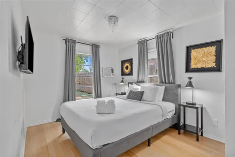 a bedroom with a bed and window