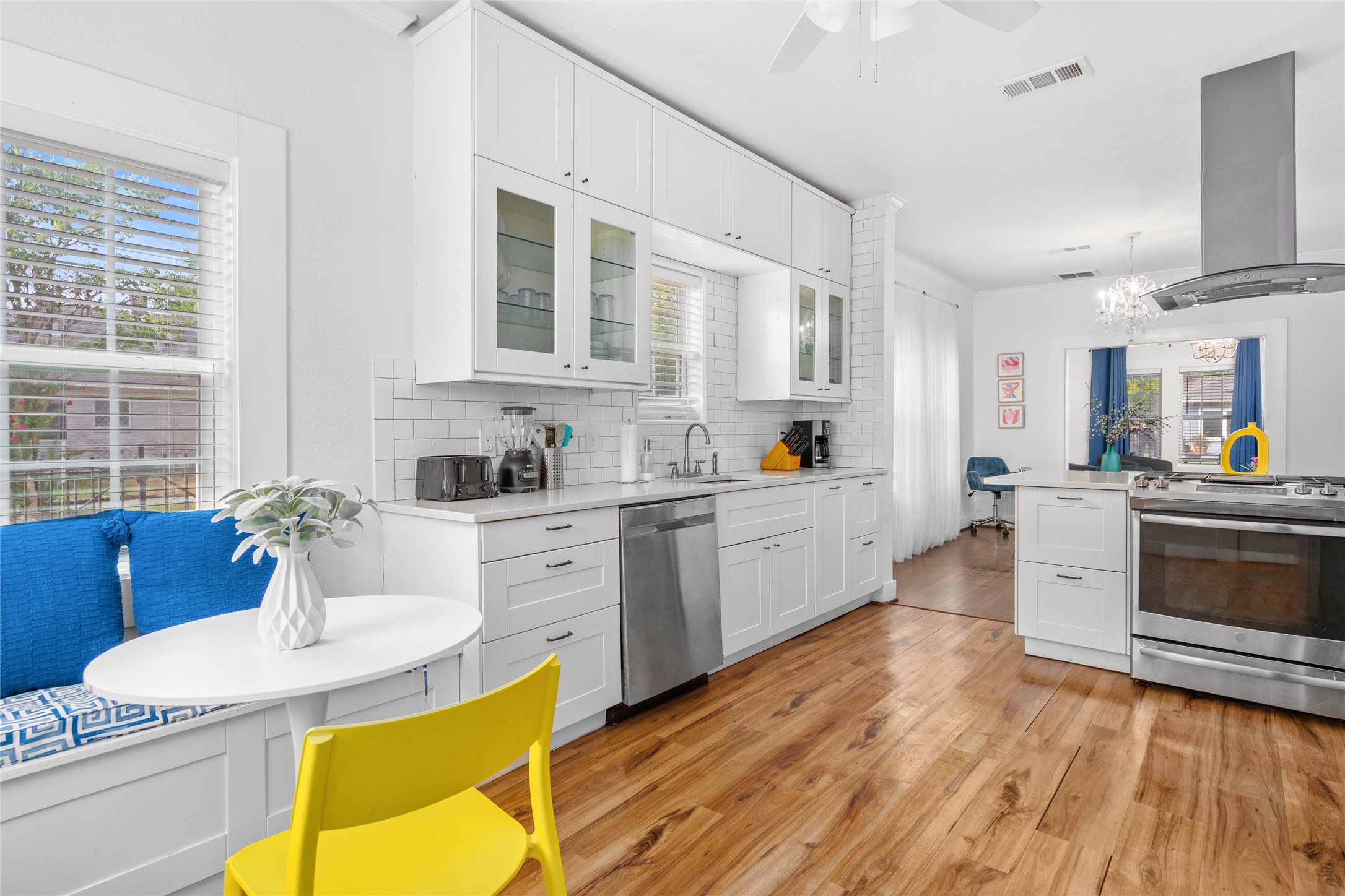 5302 Lindsay Street Houston, TX 77023 - Photo 10 of 37 a kitchen with stainless steel appliances kitchen island granite countertop a sink dishwasher stove and white cabinets with wooden floor