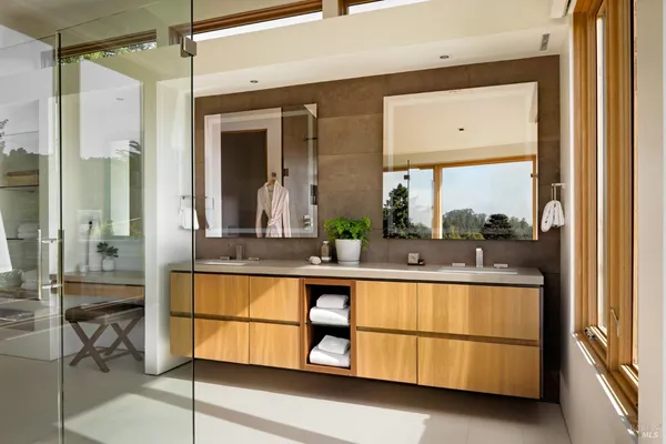 a spacious bathroom with a double vanity sink and a mirror