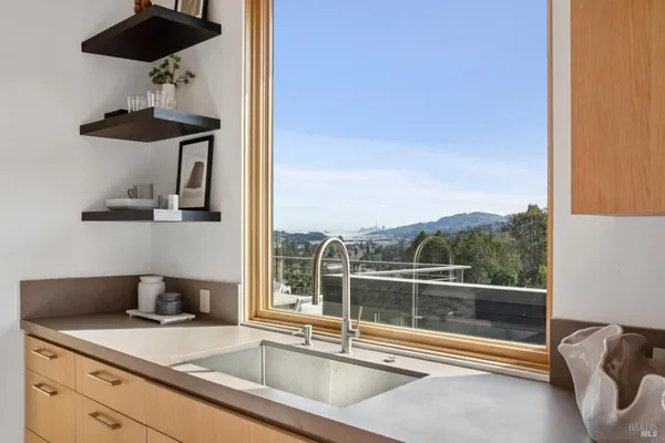 a view of a living room and kitchen with a sink and dishwasher