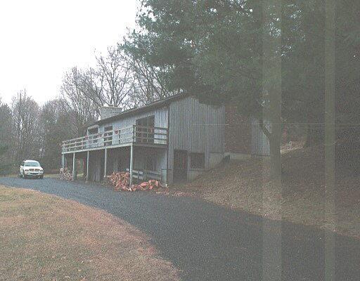 a front view of a house with basket ball court and outdoor seating