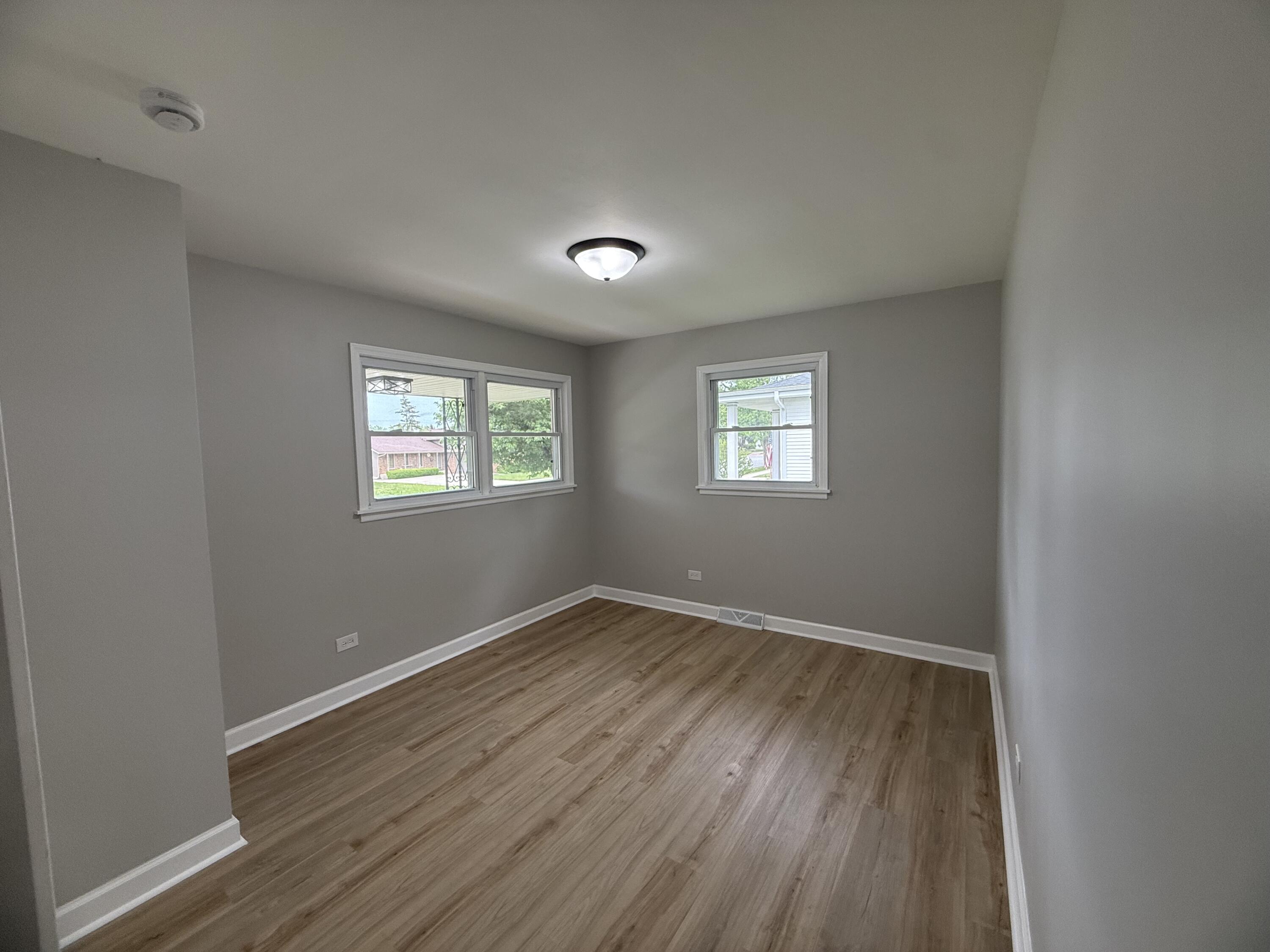 408 Cherry Hill Road Dyer, IN 46311 - Photo 16 of 31 an empty room with wooden floor and windows