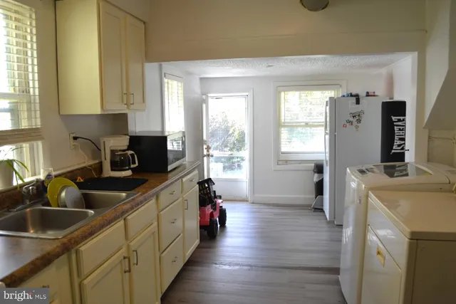 a kitchen with a sink stove and refrigerator