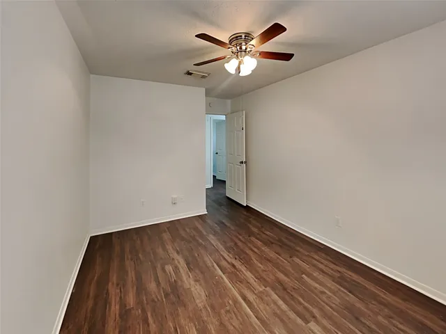 wooden floor in a hall with a chandelier