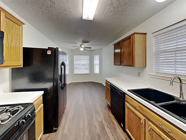 a kitchen with stainless steel appliances a stove sink and refrigerator