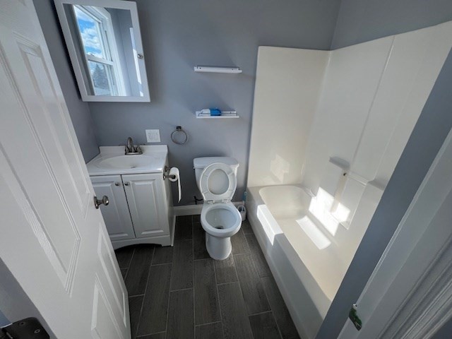 1414 Plymouth Avenue, Unit 2 Fall River, MA 02721 - Photo 2 of 7 a bathroom with a toilet sink and mirror