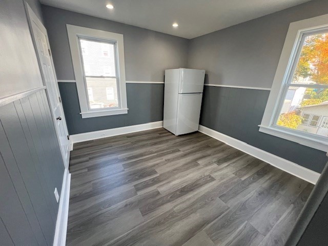 1414 Plymouth Avenue, Unit 2 Fall River, MA 02721 - Photo 3 of 7 a view of an empty room with wooden floor and a window