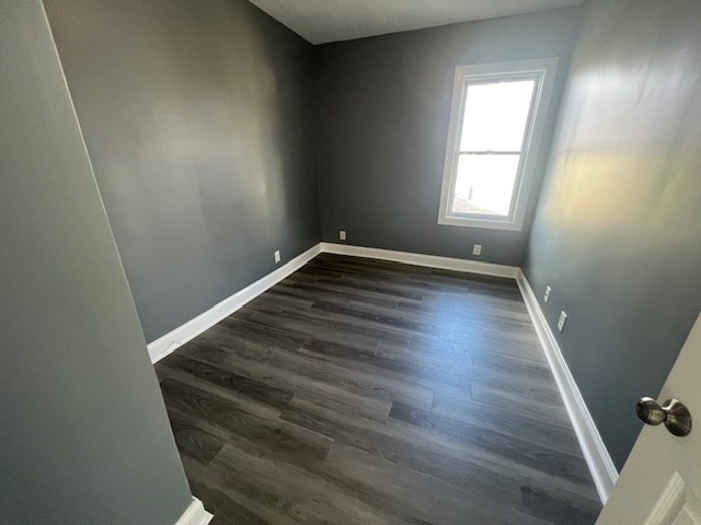 1414 Plymouth Avenue, Unit 2 Fall River, MA 02721 - Photo 6 of 7 an empty room with wooden floor and windows