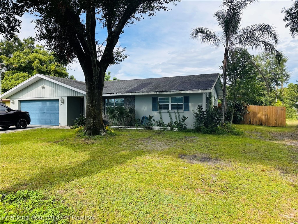 119 Parkview Road Sebring, FL 33870 - Photo 1 of 19 a front view of house with yard and trees