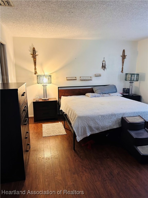 119 Parkview Road Sebring, FL 33870 - Photo 8 of 19 a bedroom with a bed and wooden floor