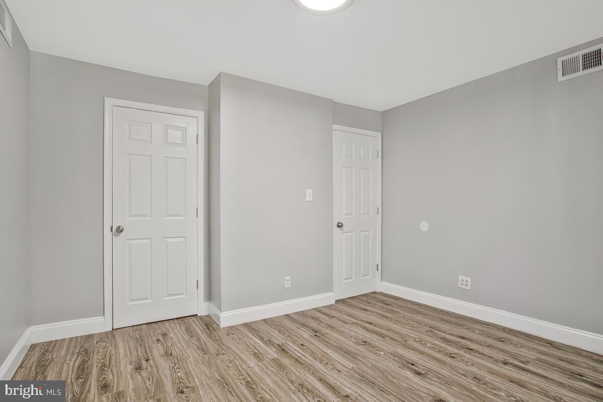 823 Newington Avenue Baltimore, MD 21217 - Photo 14 of 30 a view of an empty room with wooden floor