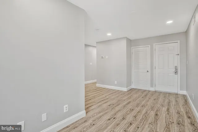 a view of wooden floor and closet in a room