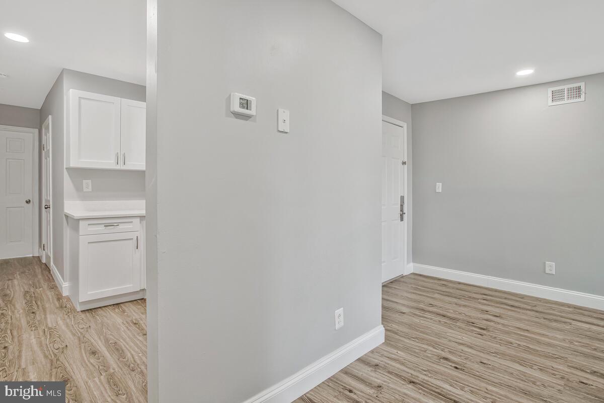 823 Newington Avenue Baltimore, MD 21217 - Photo 21 of 30 a view of wooden floor and closet in a room