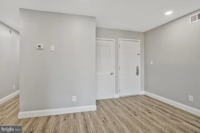 a view of a room with wooden floor