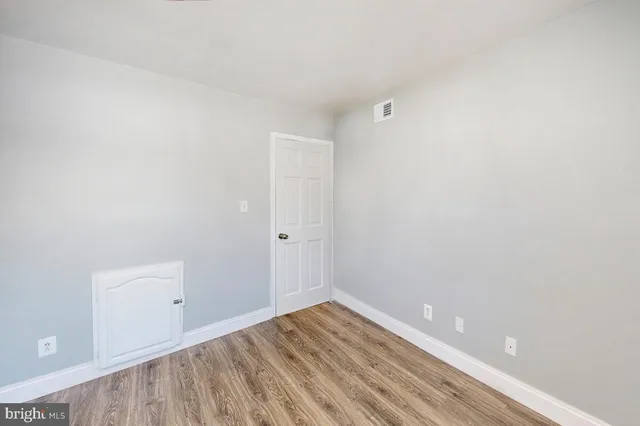 a front view of a house with a tree