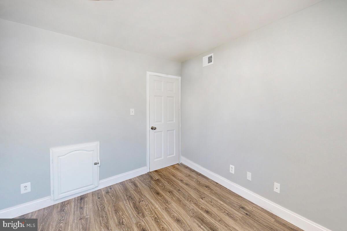 823 Newington Avenue Baltimore, MD 21217 - Photo 28 of 30 a view of an empty room with wooden floor