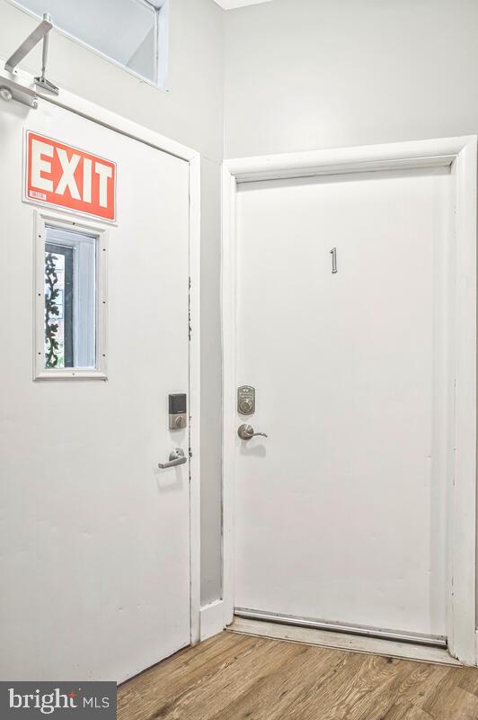 823 Newington Avenue Baltimore, MD 21217 - Photo 3 of 30 a view of a hallway with wooden floor