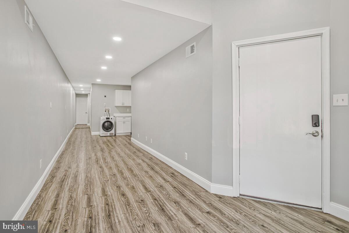 823 Newington Avenue Baltimore, MD 21217 - Photo 5 of 30 a view of empty room with wooden floor