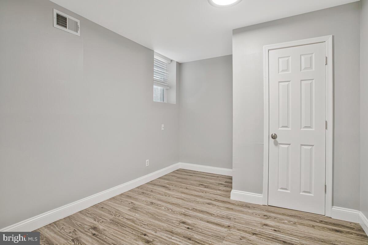 823 Newington Avenue Baltimore, MD 21217 - Photo 9 of 30 a view of an empty room with wooden floor
