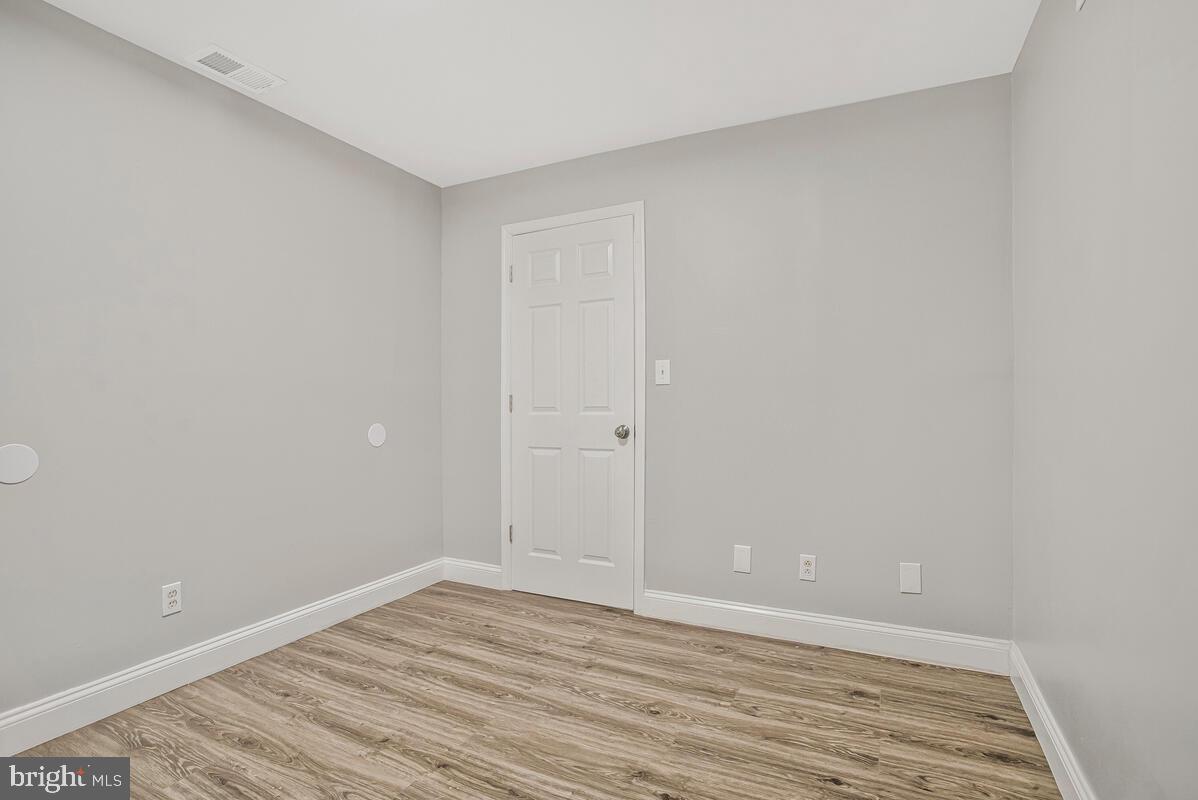 823 Newington Avenue Baltimore, MD 21217 - Photo 10 of 30 a view of an empty room with wooden floor