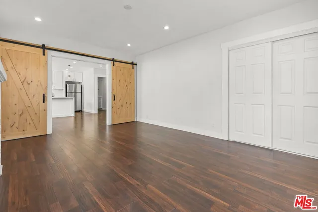 a view of a hallway with wooden floor
