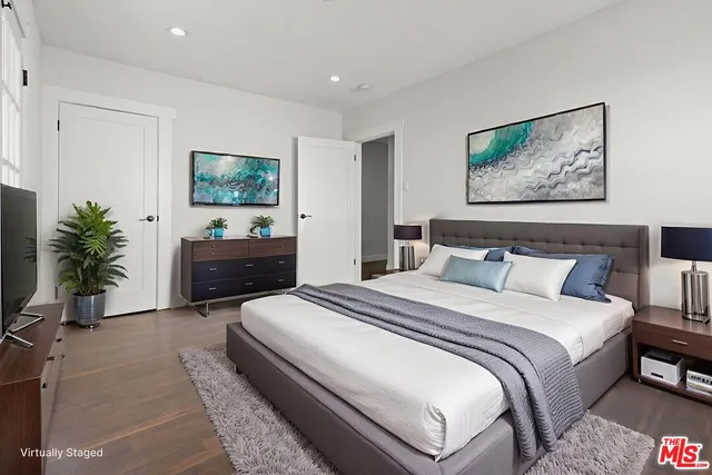 a bedroom with bed and a chandelier