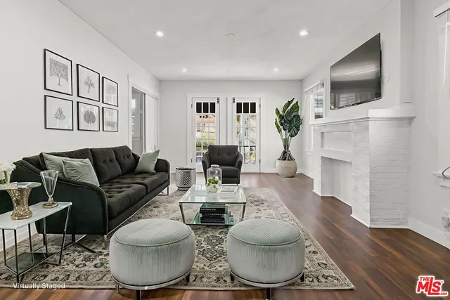 a living room with furniture a fireplace and a flat screen tv