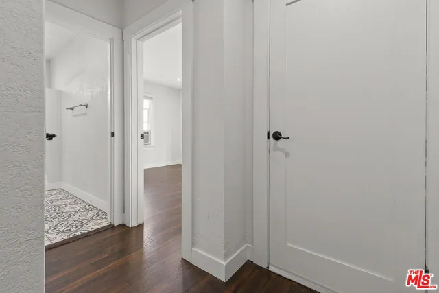 a view of a hallway with wooden floor
