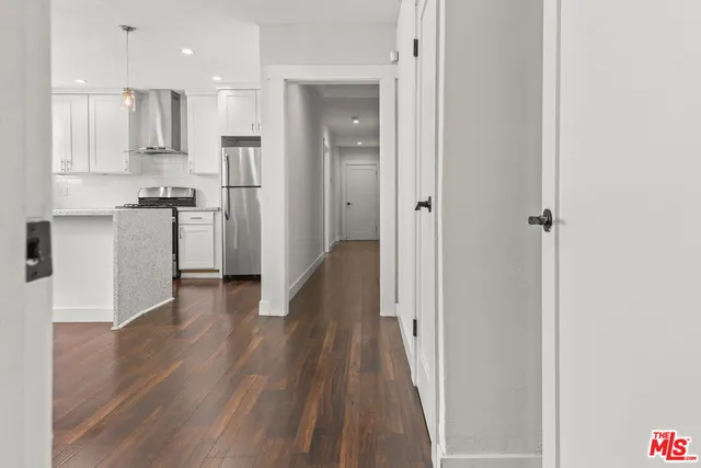 a view of a kitchen with a refrigerator and a microwave