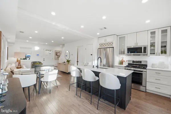 a large kitchen with a table and chairs