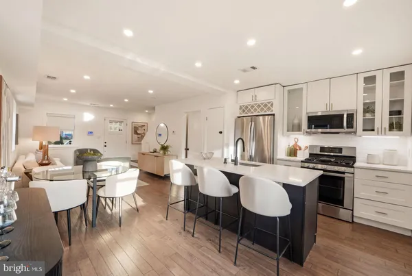 a large kitchen with a table and chairs