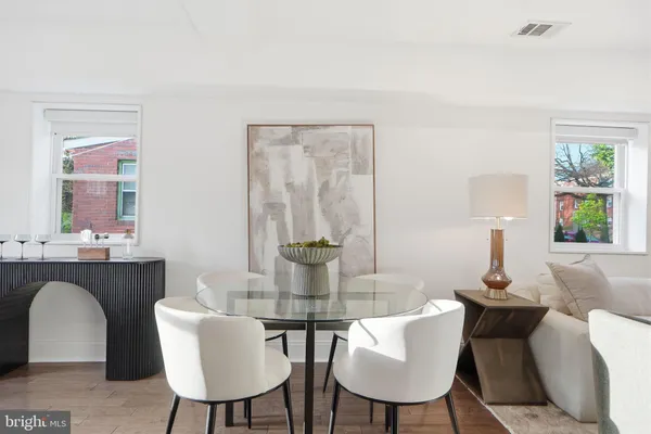 a dining room with furniture and window