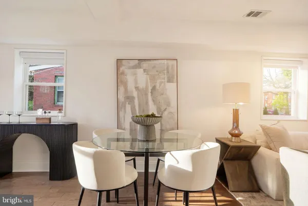 a dining room with furniture and window