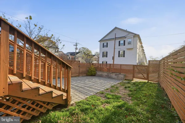 a view of house with a small yard and potted plants