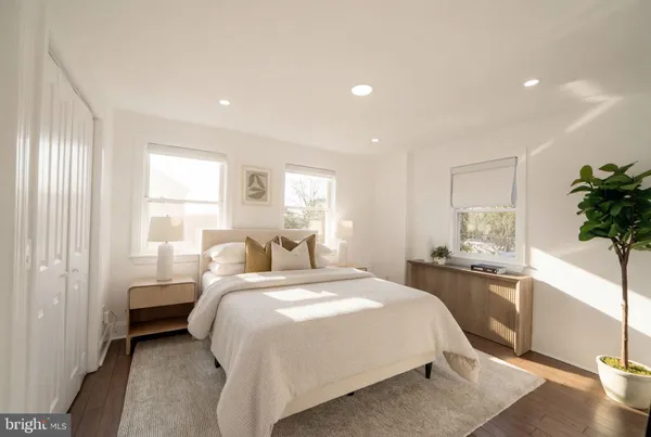 a bedroom with a bed and a large window